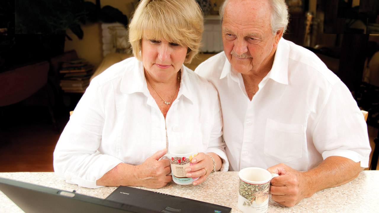 Senior couple using a laptop